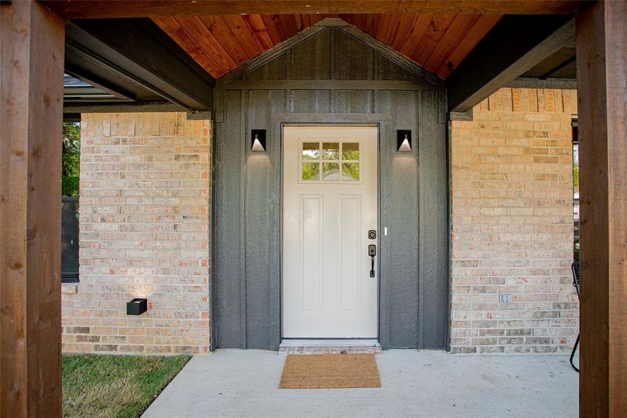 Entrance to property with brick siding and board and batten siding Entrance to property with brick siding and board and batten siding