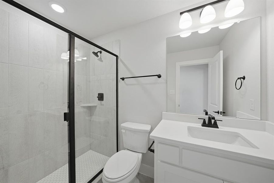 Bathroom featuring vanity and a shower stall