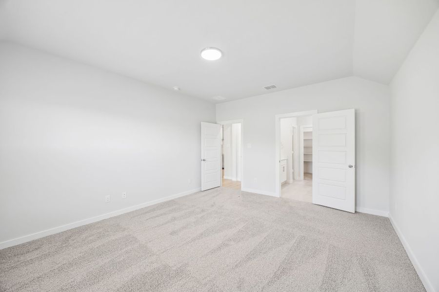 Primary bedroom in the Heisman home plan by Trophy Signature Homes – REPRESENTATIVE PHOTO Primary bedroom in the Heisman home plan by Trophy Signature Homes – REPRESENTATIVE PHOTO