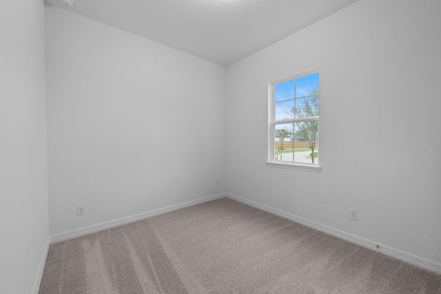 Your secondary bedroom features plush carpet, fresh paint, closet, and a large window that lets in plenty of natural lighting.