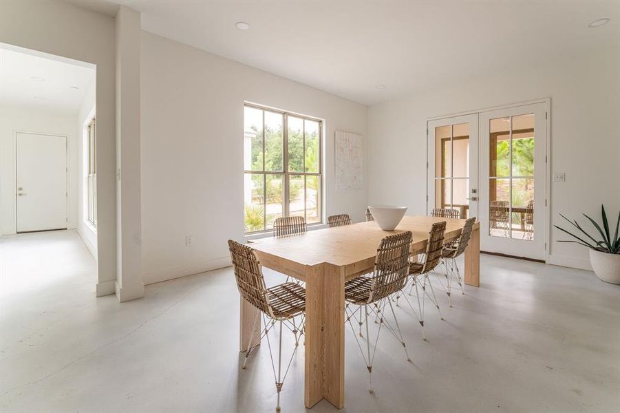 Kitchen featuring pendant lighting, tasteful backsplash, white cabinetry, and light stone counters Kitchen featuring pendant lighting, tasteful backsplash, white cabinetry, and light stone counters