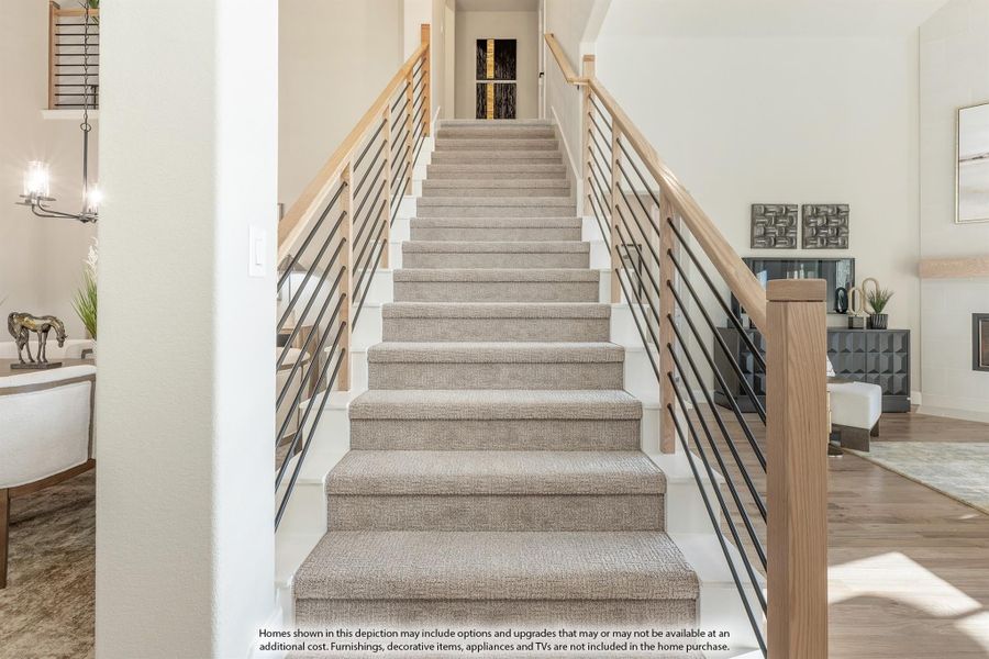 Carpeted staircase with wood and metal horizontal railings leading to upper floor hallway Carpeted staircase with wood and metal horizontal railings leading to upper floor hallway