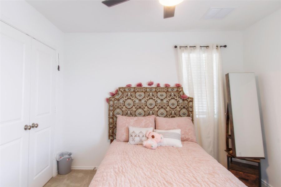 Bedroom with a closet and a ceiling fan