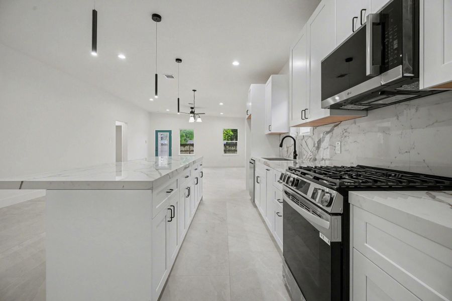Kitchen with porcelain countertops and a large island