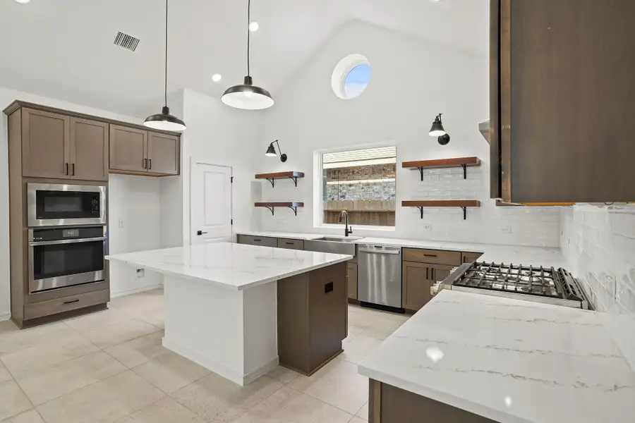 Gourmet island kitchen with quartz countertops and light stain cabinets (*Photo not of actual home and used for illustration purposes only.) Gourmet island kitchen with quartz countertops and light stain cabinets (*Photo not of actual home and used for illustration purposes only.)