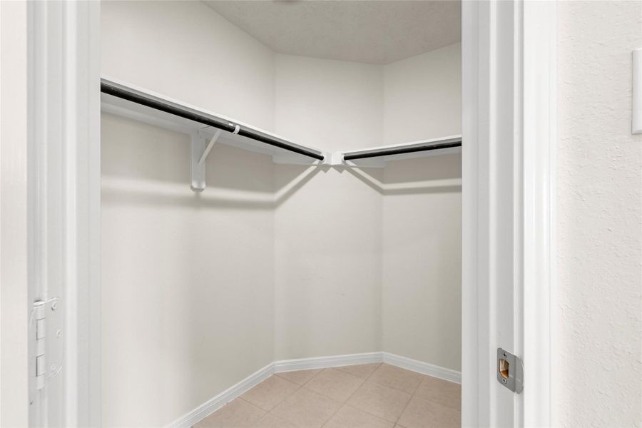 1 of 2 walk-in closets in the primary bedroom. 1 of 2 walk-in closets in the primary bedroom.