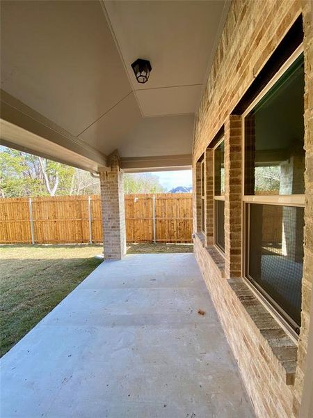 Nice covered back patio to enjoy the tree line and BBQ Nice covered back patio to enjoy the tree line and BBQ