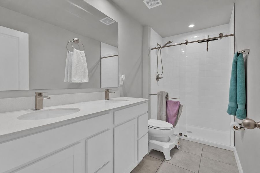 Dual sinks, glass shower enclosure
