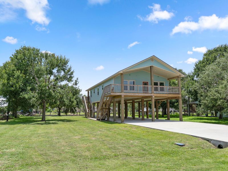 Front exterior of a new home in , Sargent, TX, highlighting curb appeal (Image 21). Front exterior of a new home in , Sargent, TX, highlighting curb appeal (Image 21).