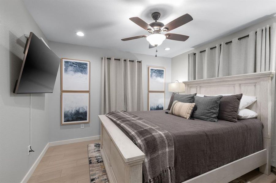 Bedroom featuring light wood-type flooring, a ceiling fan, and recessed lighting Bedroom featuring light wood-type flooring, a ceiling fan, and recessed lighting