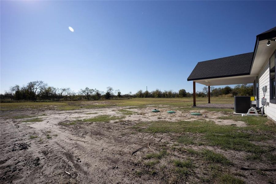 View of yard with a rural view