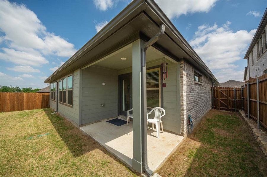 Rear view of property featuring a patio and a yard