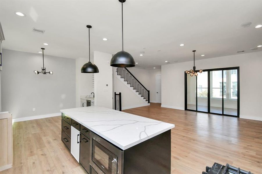 Quartz countertops and custom cabinetry elevate the space.