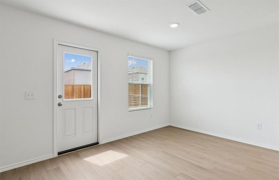 Dining nook off kitchen with large windows