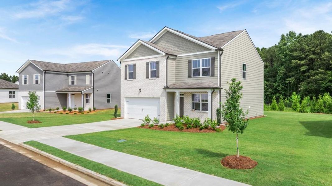 Front exterior of a new home in Oaks at Cedar Grove, Fairburn, GA, highlighting curb appeal (Image 1). Front exterior of a new home in Oaks at Cedar Grove, Fairburn, GA, highlighting curb appeal (Image 1).