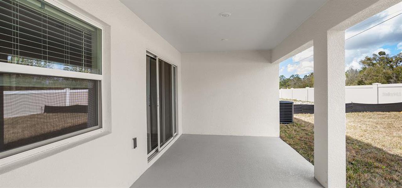 Exterior details and patio area of a home in Estates at Hickory Cove - Single-Family Homes, St. Cloud (Image 2).