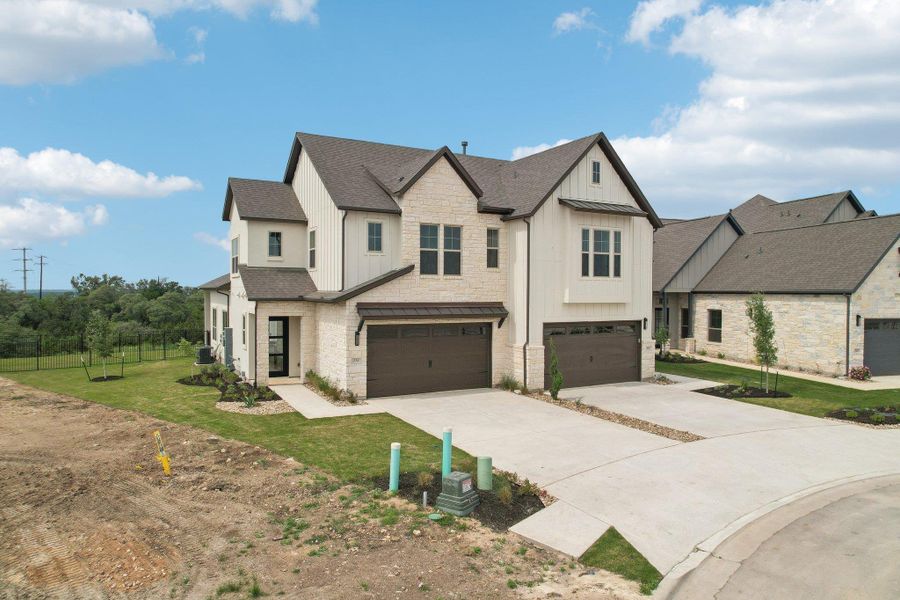 View of front of home with concrete driveway, stone siding, board and batten siding, an attached garage, and roof with shingles View of front of home with concrete driveway, stone siding, board and batten siding, an attached garage, and roof with shingles
