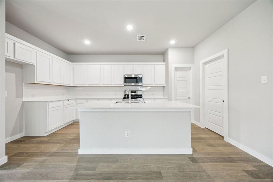 Kitchen in the Hayden home plan by Trophy Signature Homes – REPRESENTATIVE PHOTO