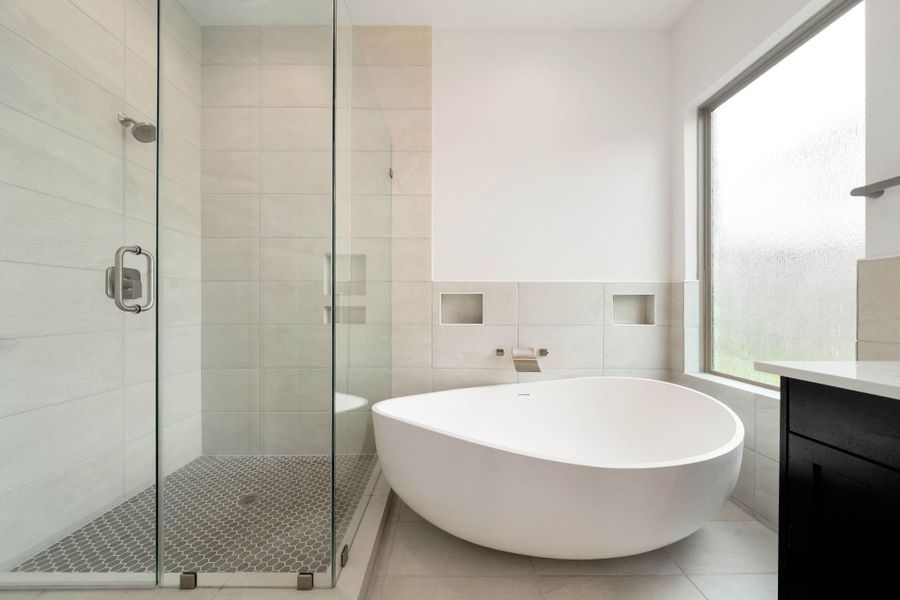 The shower has been extended and glass walls have been added. You have to check out the size of this tub in person... it is massive!