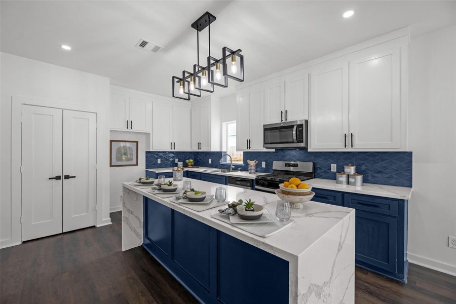 Island with marble-style countertops offers seating and is illuminated by a stylish pendant light. The space is bright and contemporary, ideal for cooking and entertaining. Island with marble-style countertops offers seating and is illuminated by a stylish pendant light. The space is bright and contemporary, ideal for cooking and entertaining.