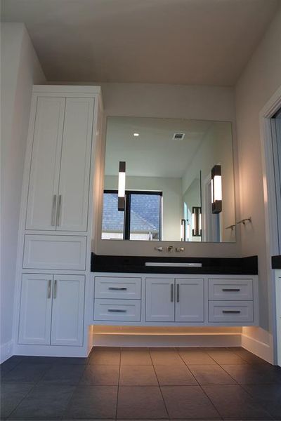 Bathroom with tile patterned floors and vanity