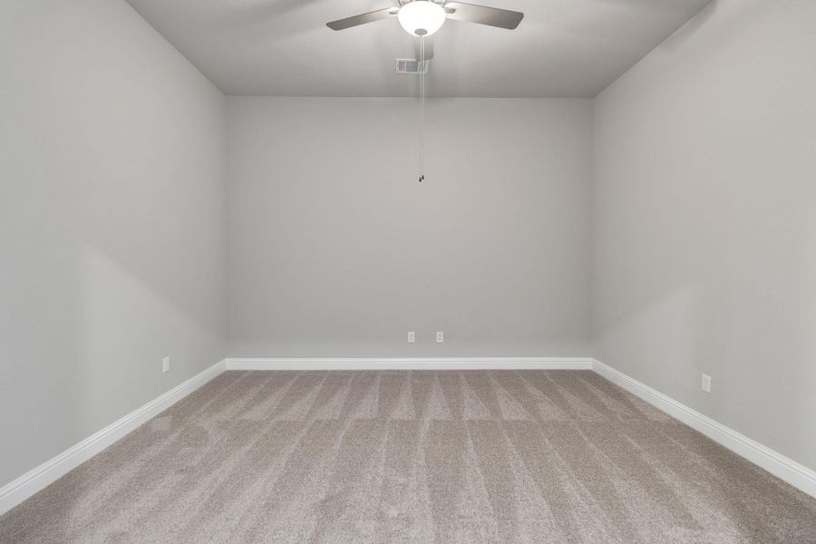 Carpeted empty room with visible vents, baseboards, and ceiling fan Carpeted empty room with visible vents, baseboards, and ceiling fan