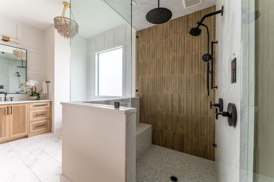 Full bath with vanity, walk in shower, and light marble finish flooring Full bath with vanity, walk in shower, and light marble finish flooring