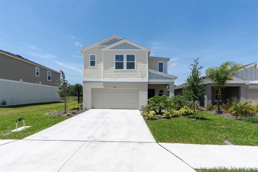 Front exterior of a new home in Crosswind Point, Parrish, FL, highlighting curb appeal (Image 22).