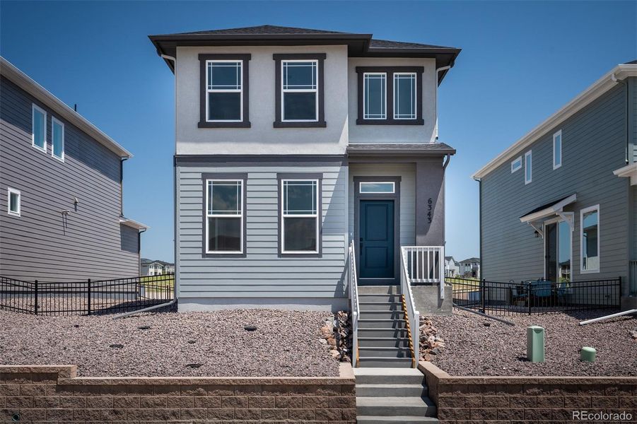 Front exterior of a home in the Revel Crossing at Wolf Ranch – The Ascent Collection community, located in Colorado Springs, CO (Image 14).
