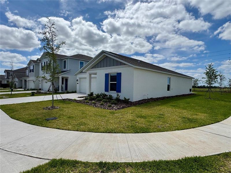 Front exterior of a new home in Hamilton Bluff, Haines City, FL, highlighting curb appeal (Image 15).