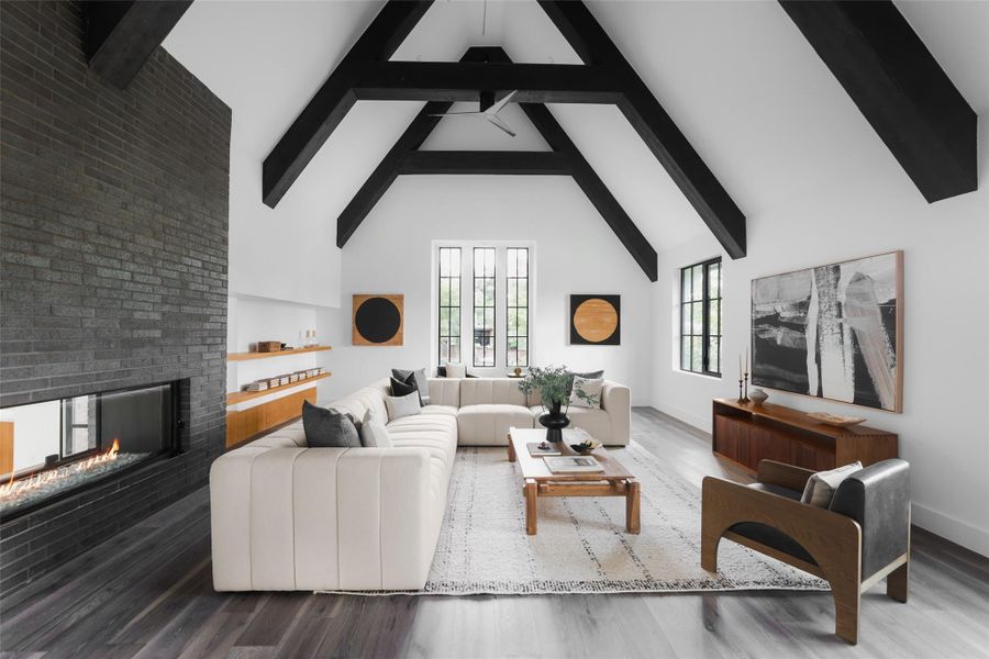 The living room features a striking double-sided fireplace that adds warmth and charm, creating a cozy yet sophisticated ambiance that flows effortlessly between spaces.