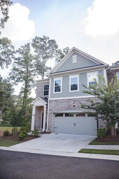Front exterior of a new home in , Woodstock, GA, highlighting curb appeal (Image 10).