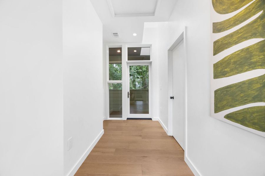 Hall featuring light wood finished floors and recessed lighting