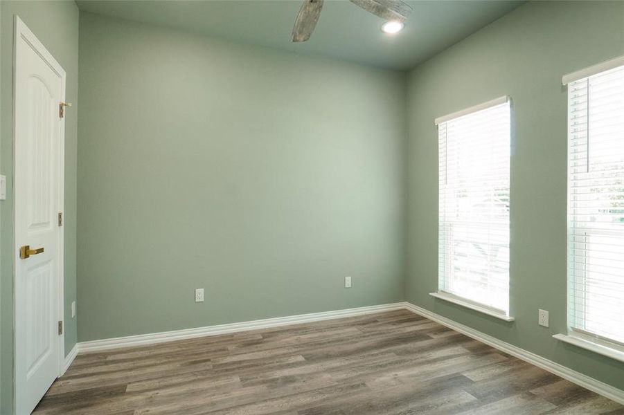 Spare room with hardwood / wood-style flooring and a healthy amount of sunlight