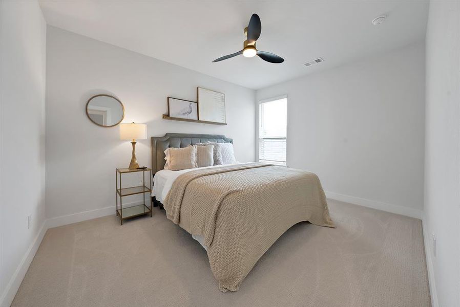 Neutral-toned carpeted room featuring a ceiling fan with integrated lighting, a single window with blinds, and white baseboards Neutral-toned carpeted room featuring a ceiling fan with integrated lighting, a single window with blinds, and white baseboards