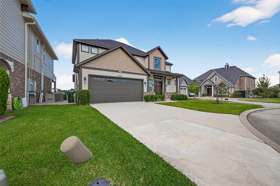 Full-property view highlighting the home’s blend of modern and traditional design, manicured lawn, and private fenced backyard access. Full-property view highlighting the home’s blend of modern and traditional design, manicured lawn, and private fenced backyard access.