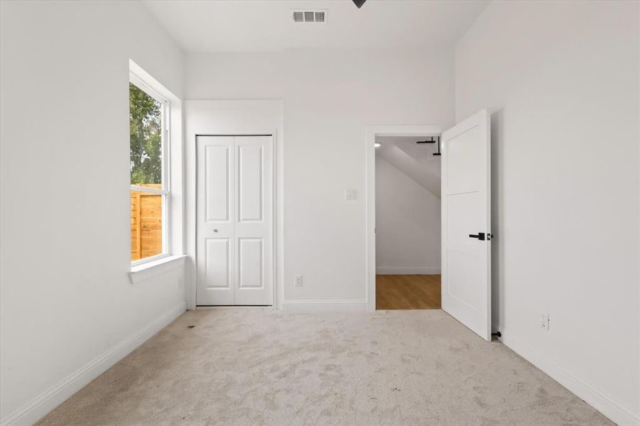 Unfurnished bedroom featuring light colored carpet and a closet Unfurnished bedroom featuring light colored carpet and a closet