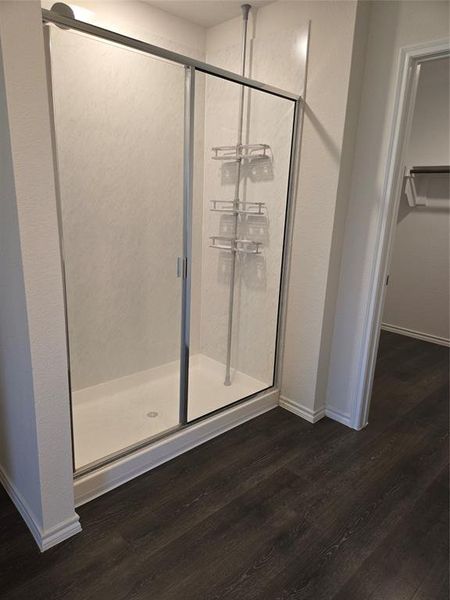 Bathroom featuring hardwood / wood-style flooring and walk in shower