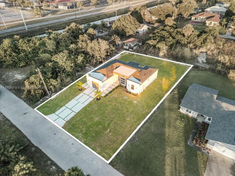 Front exterior of a new home in , Lehigh Acres, FL, highlighting curb appeal (Image 20).