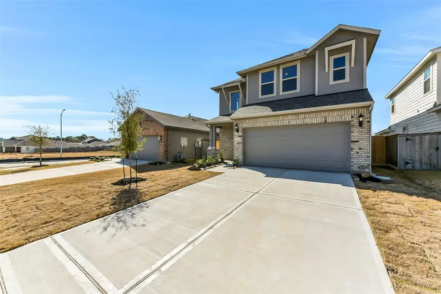 Front exterior of a new home in Colony at Pinehurst, Pinehurst, TX, highlighting curb appeal (Image 1). Front exterior of a new home in Colony at Pinehurst, Pinehurst, TX, highlighting curb appeal (Image 1).