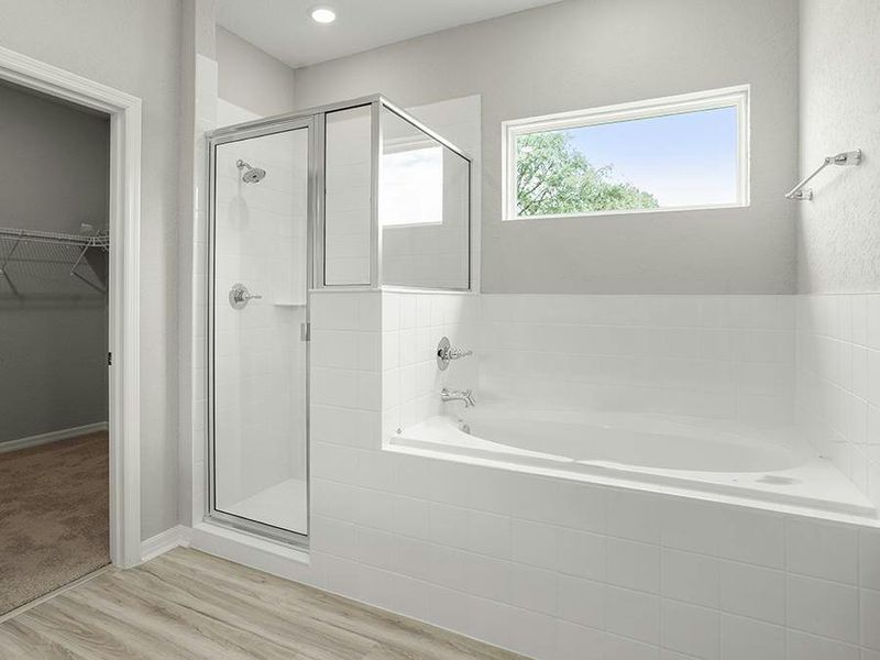 Enjoy spa-like relaxation with a tiled shower and garden tub - Willow II with Loft by Highland Homes