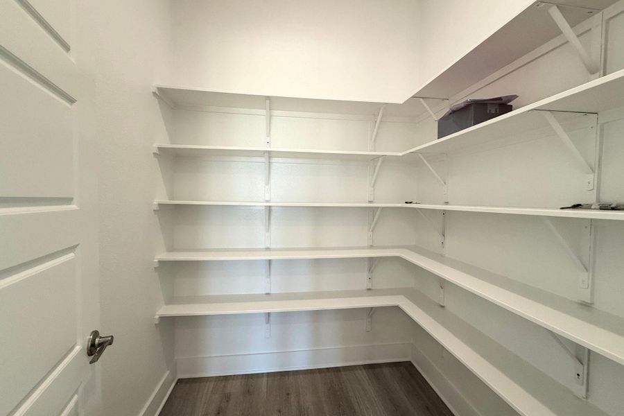 Ample shelving in this walk-in pantry provides generous storage solutions. Ample shelving in this walk-in pantry provides generous storage solutions.
