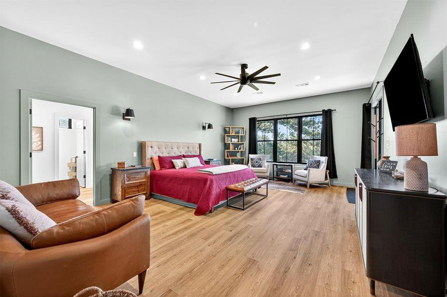 Bedroom featuring light wood-style flooring, recessed lighting, and a ceiling fan Bedroom featuring light wood-style flooring, recessed lighting, and a ceiling fan