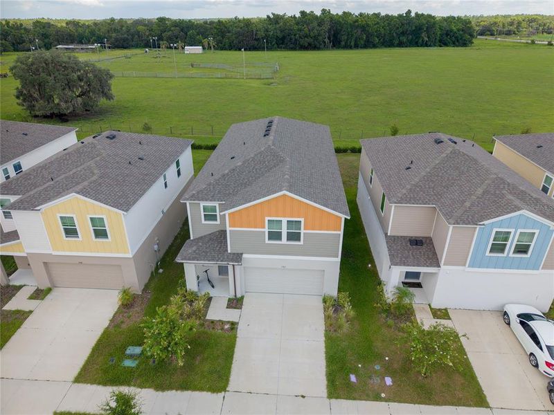 Front exterior of a new home in Pasadena Point, Wesley Chapel, FL, highlighting curb appeal (Image 23). Front exterior of a new home in Pasadena Point, Wesley Chapel, FL, highlighting curb appeal (Image 23).