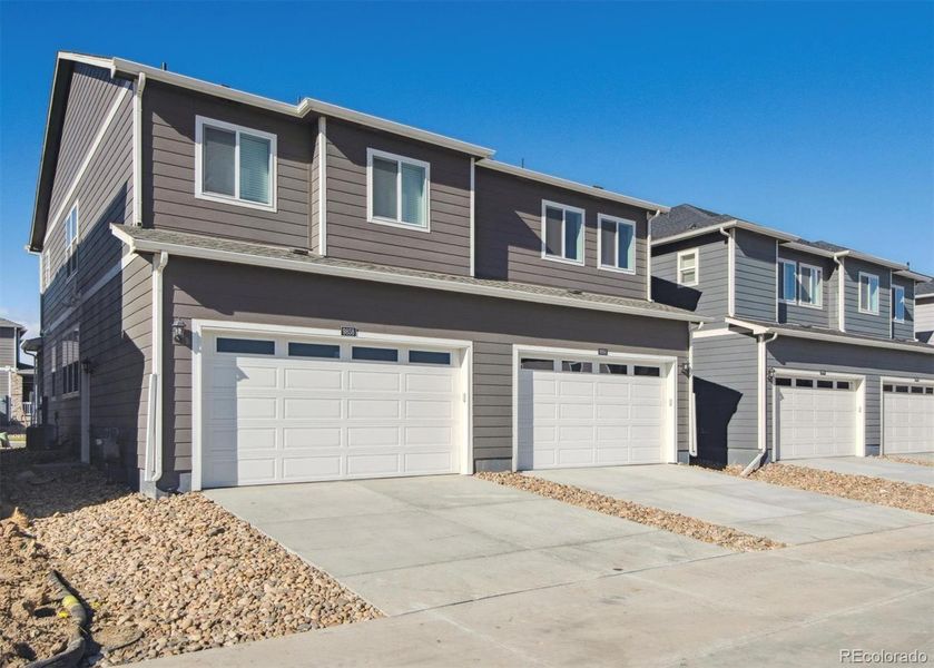 Front exterior of a new home in Settlers Crossing, Commerce City, CO, highlighting curb appeal (Image 20).