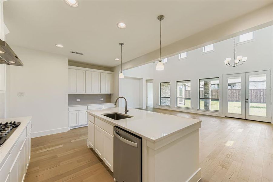 Kitchen featuring recessed lighting, white cabinetry, pendant lighting, and appliances with stainless steel finishes Kitchen featuring recessed lighting, white cabinetry, pendant lighting, and appliances with stainless steel finishes
