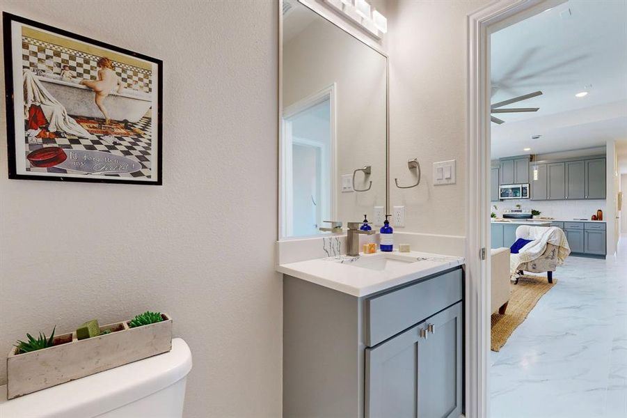 Bathroom featuring tile floors, toilet, ceiling fan, and oversized vanity