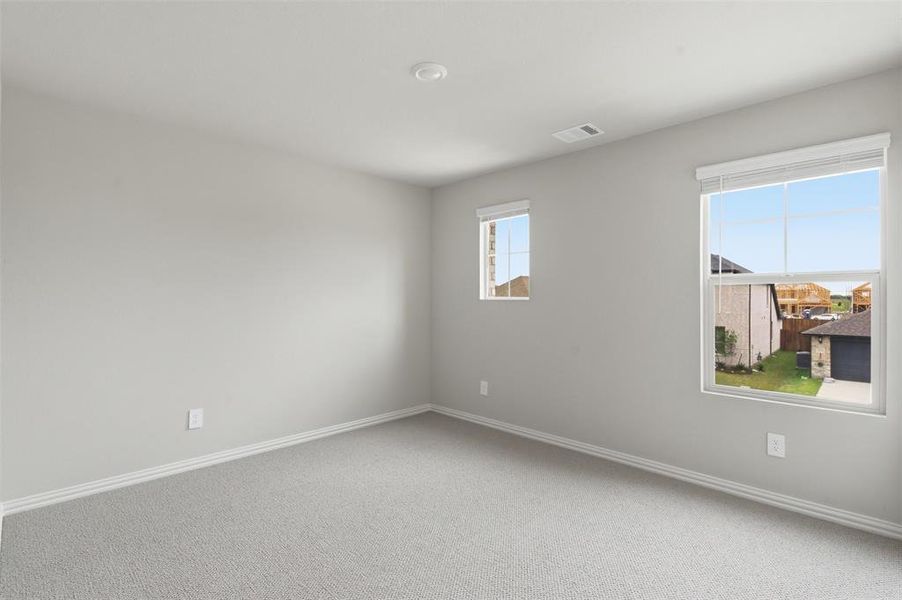 This room features light-colored carpet flooring, light gray walls, and white trim