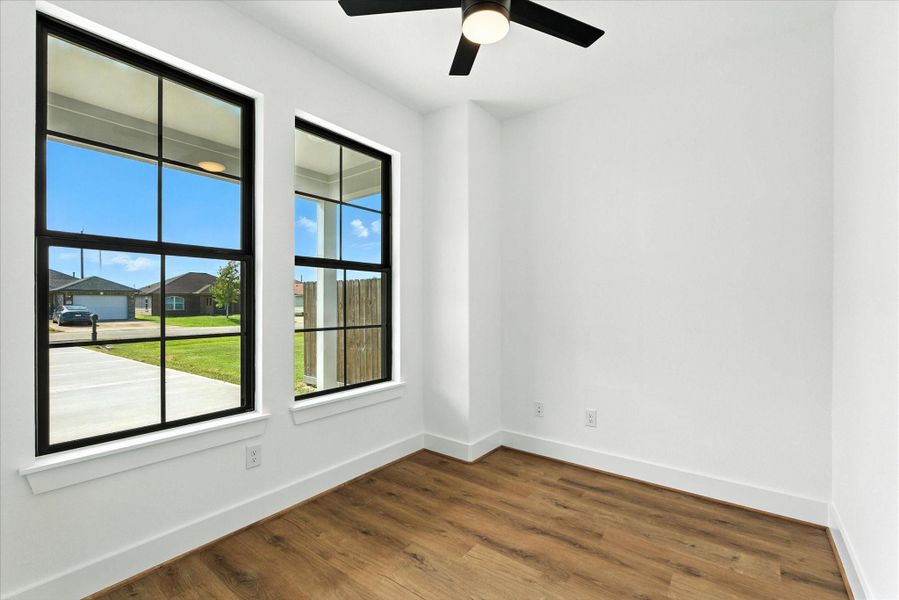 Find a flex space located off the front entrance. Large windows with a beautiful view, a ceiling fan and lovely luxury vinyl flooring. Perfect for an office, play room, or your work-from-home set up!