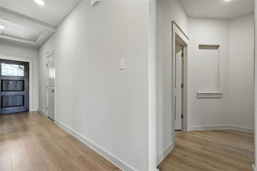 Hall featuring light wood finished floors and recessed lighting Hall featuring light wood finished floors and recessed lighting